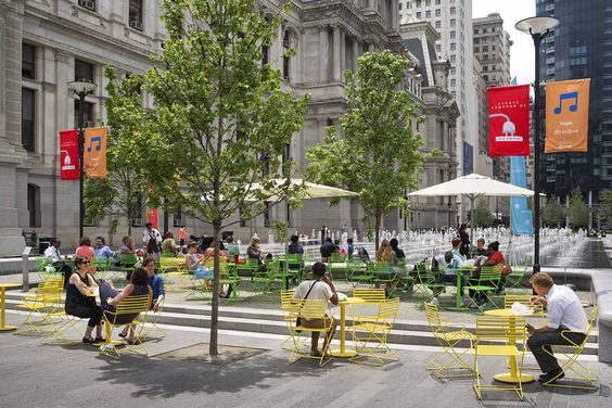 An urban park with metal movable tables and chairs